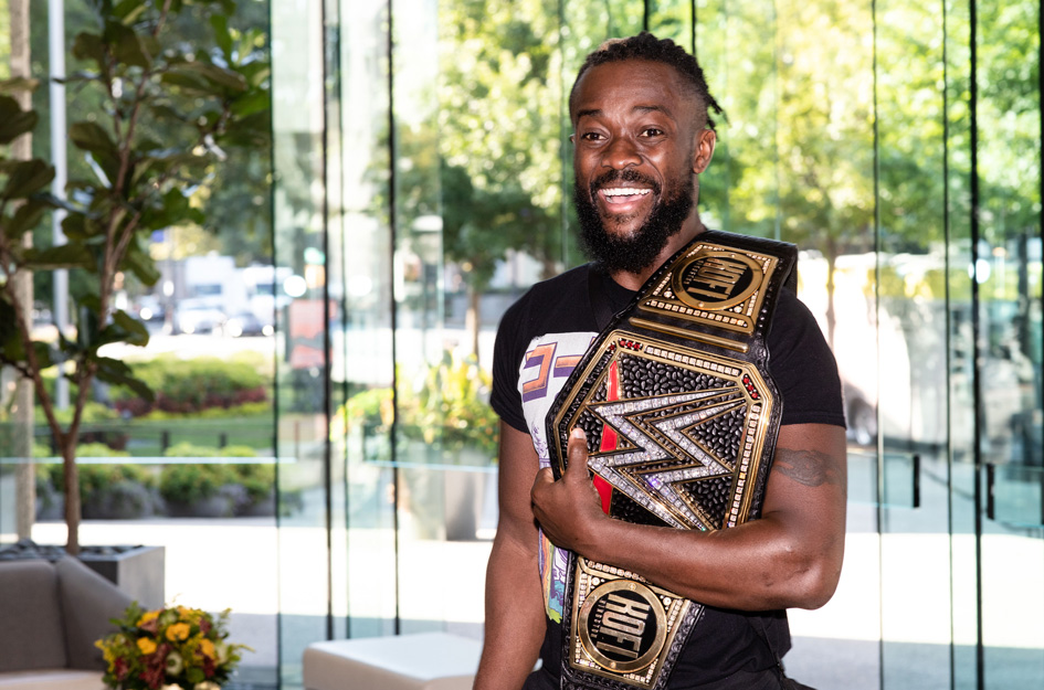 Kofi Kingston holding a trophy