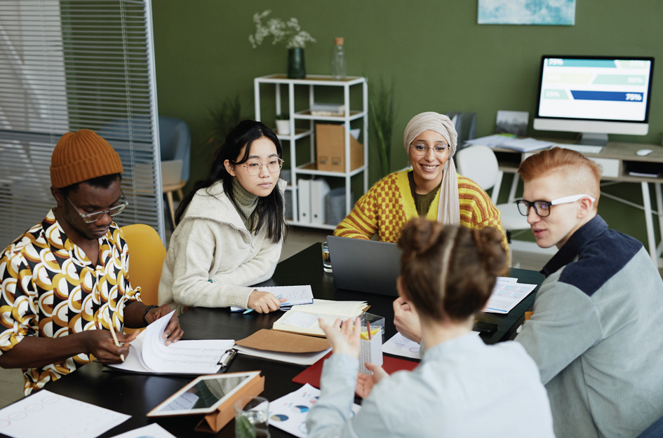 Group of diverse coworkers sitting around a conference table