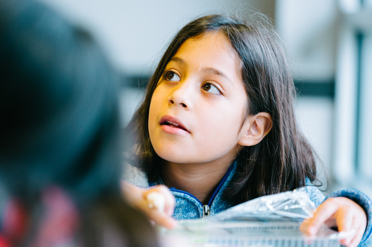 Club kid looking off to the right and working on a project