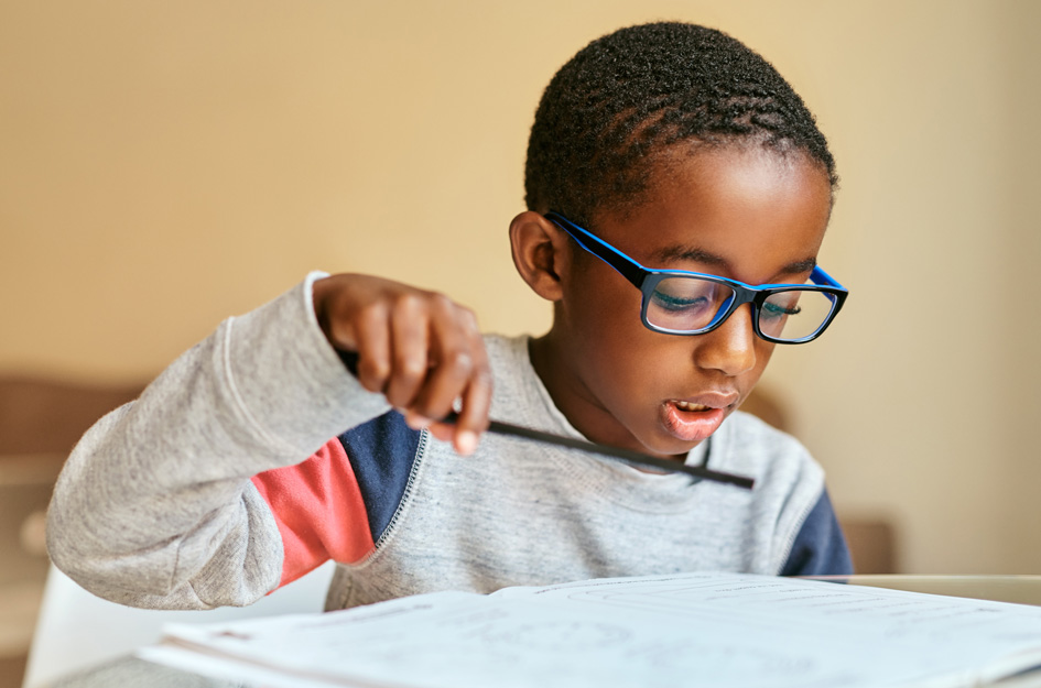 Club kid doing homework at desk