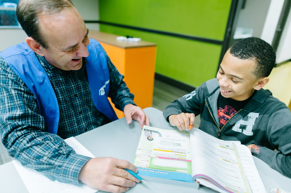 Youth Development Professional and Club kid working on homework