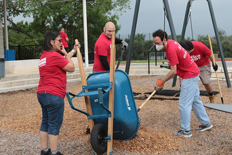 Clubs Get a Refresh - Group outside cleaning up playground