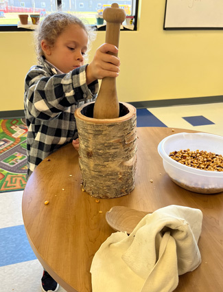 Young girl using smaller botaagan herself