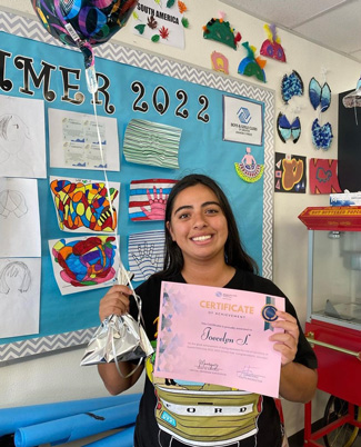 Joecelyn with certificate and balloon