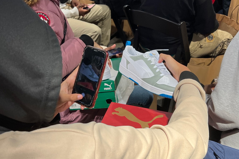 Club teen taking picture of new PUMA shoe