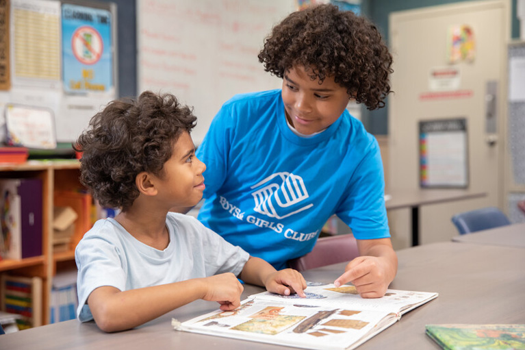Club kids reading together