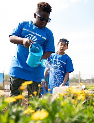 Club kids watering garden