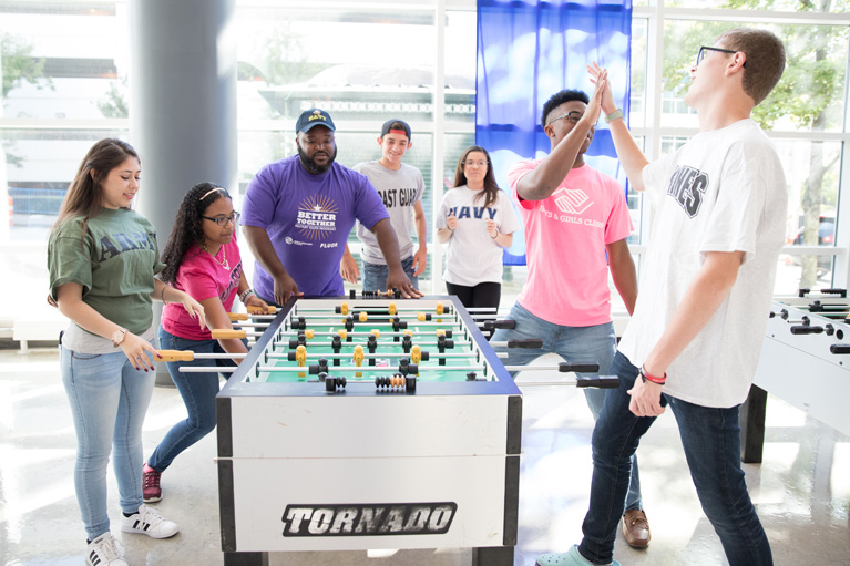 Club teens playing foosball