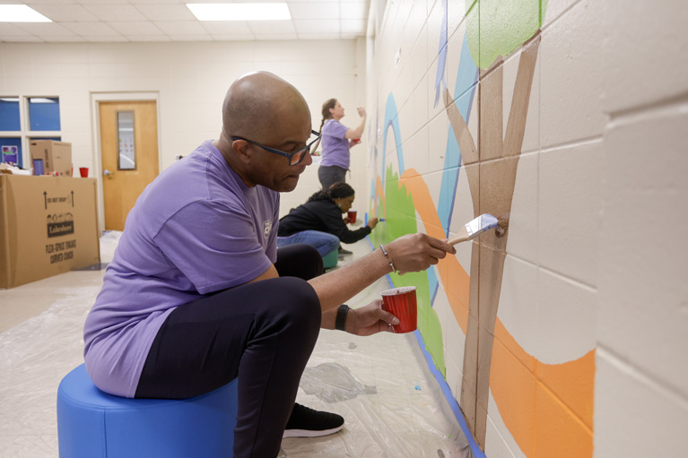 Boys & Girls Clubs of America executives help paint mural