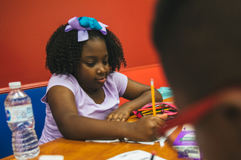 Cute Club kid working on homework