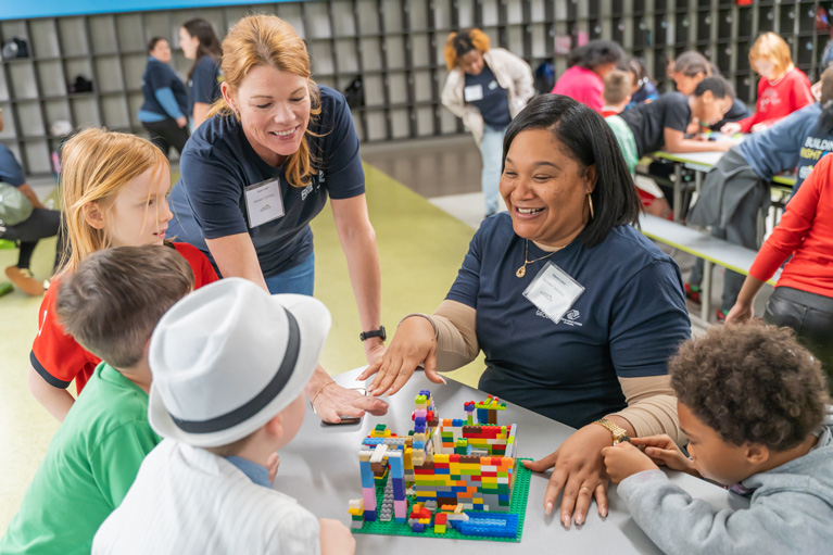 Club kids, YDP and volunteers building with building blocks