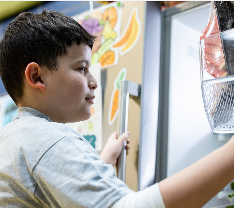 Club kid looking in fridge