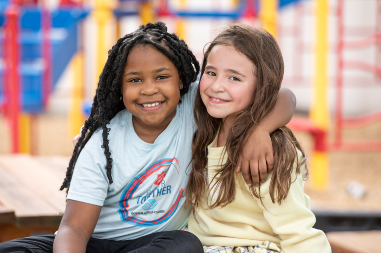 Two Club kids smiling at camera