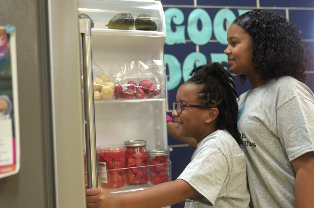 Two Club kids looking into refrigerator