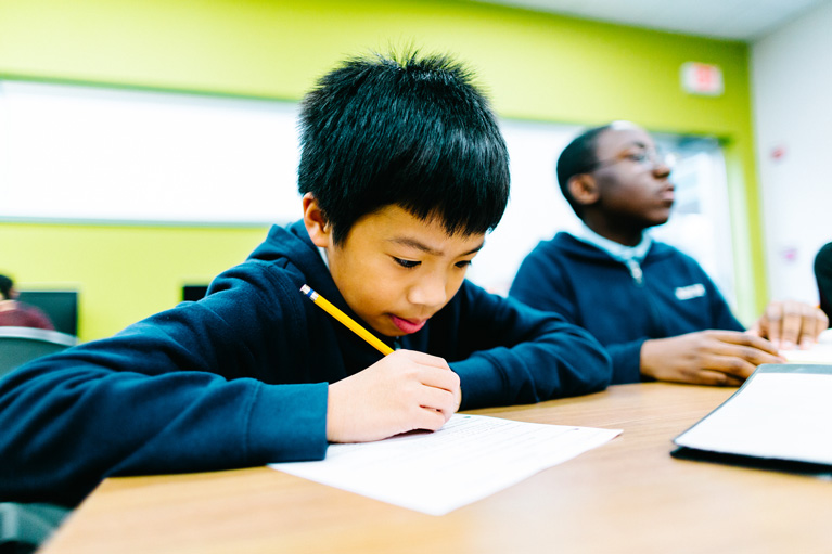 Club kid writing on paper