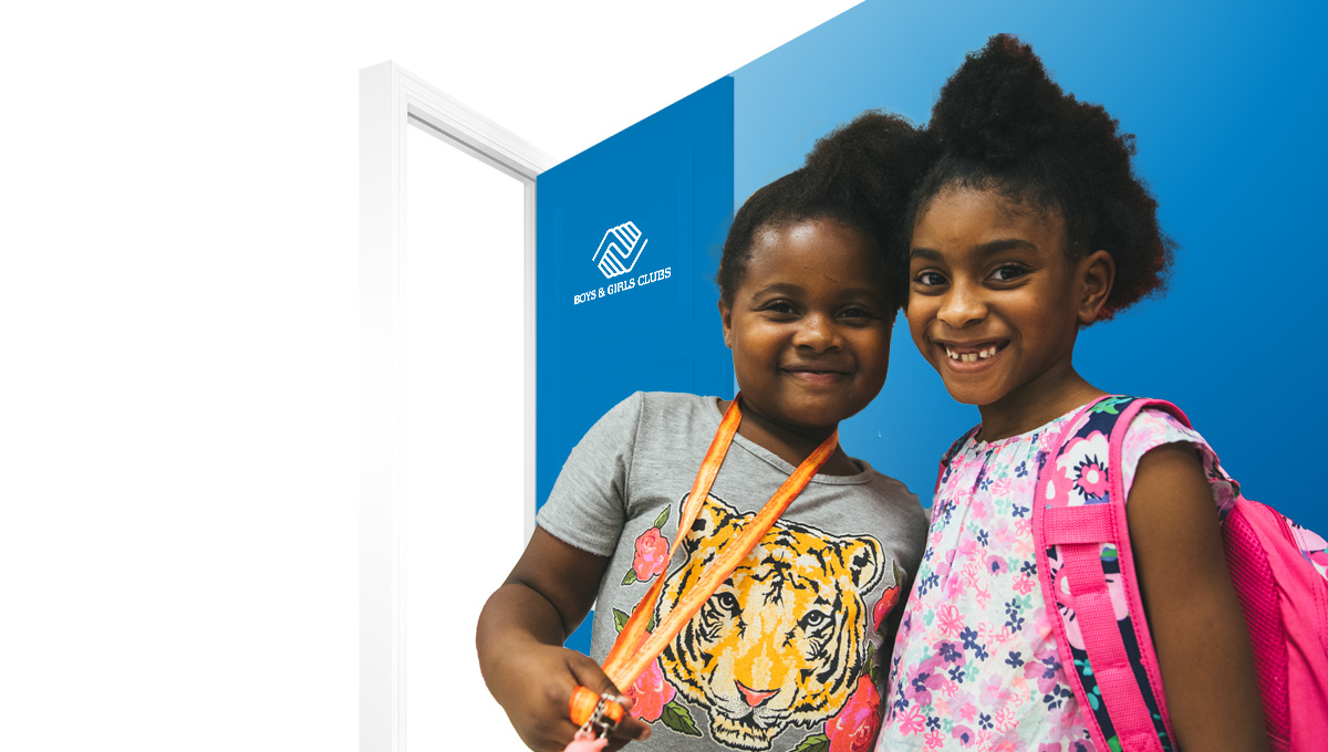 Two Club kids smiling at the camera