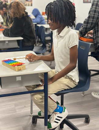Elliot playing the xylophone