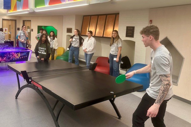 Volunteers playing ping-pong