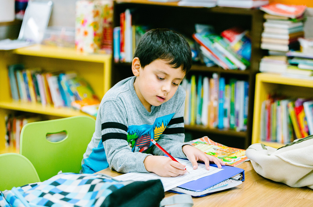 Club kid working on homework