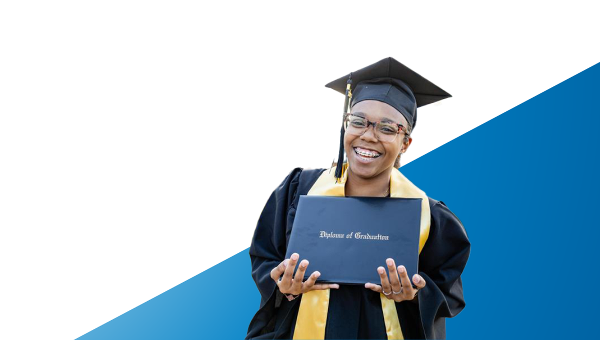 Club kid in mortarboard and gown smiling at camera and holding Diploma of Graduation
