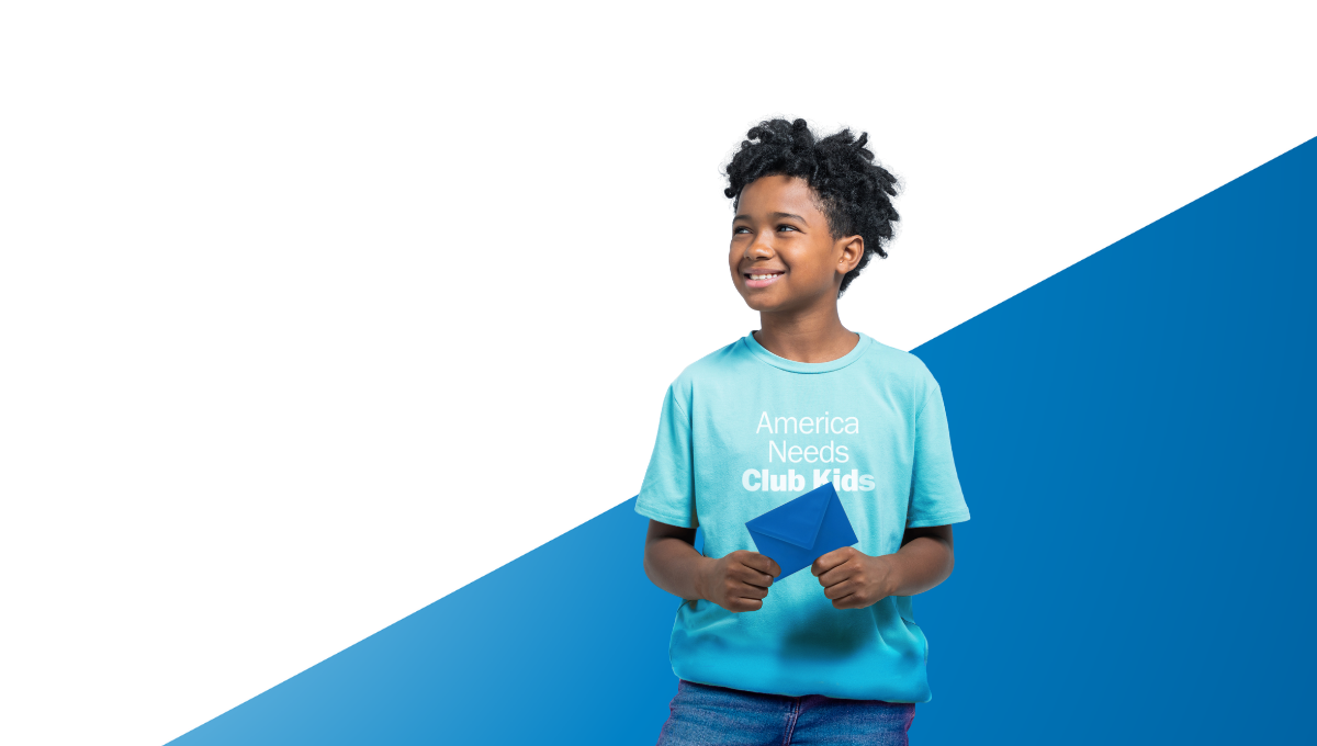 Club kid in America Needs Club Kids t-shirt holding a note card envelope