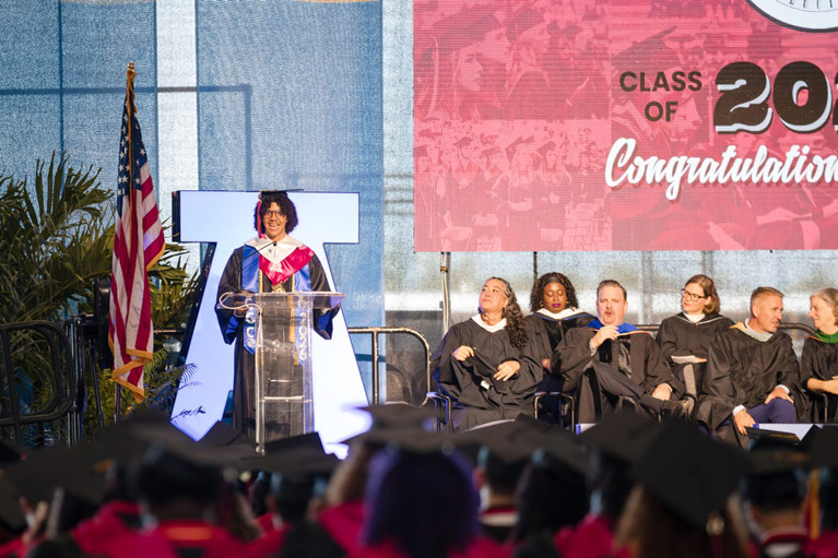 Enrique speaking at graduation as valedictorian