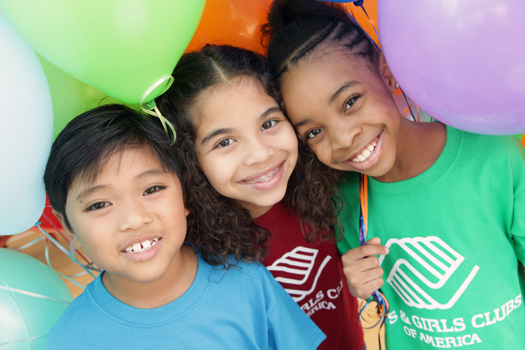 3 Club kids smiling at camera